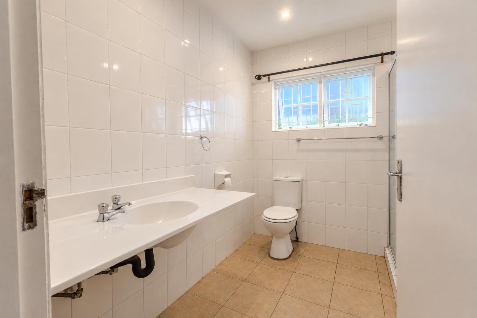 769780_Upgraded_White-Tiled_Bathroom_Interior.png